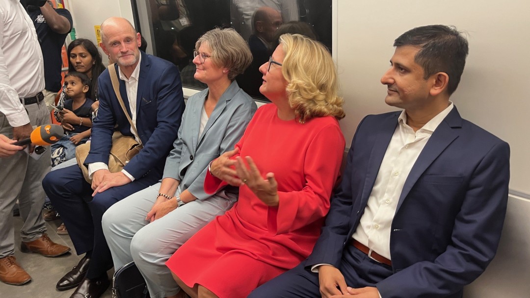 A group of people are sitting in the metro.