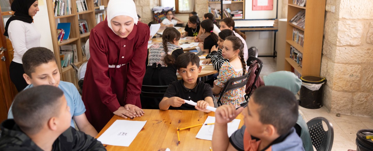 A teacher teaches schoolchildren in a classroom