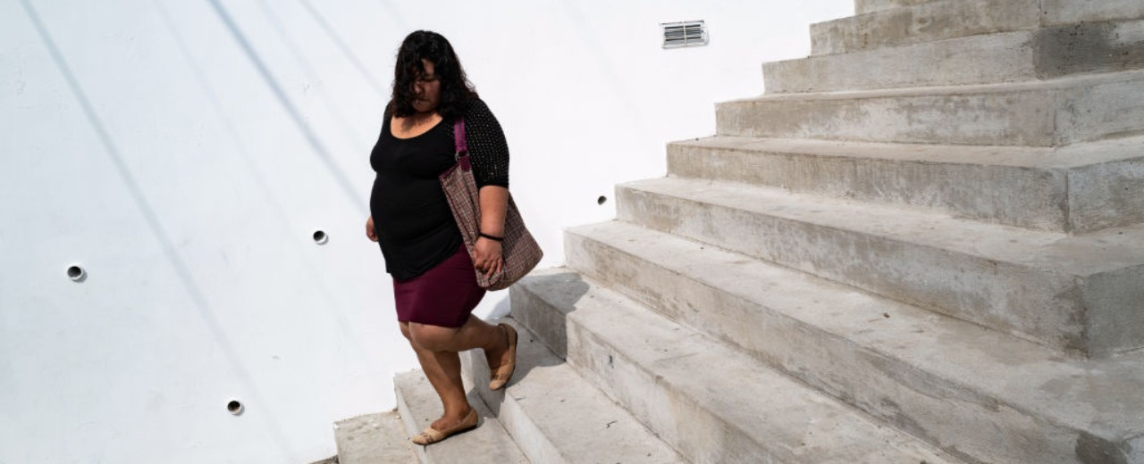 Woman walks down a flight of stairs in the city park in Colonia Kennedy