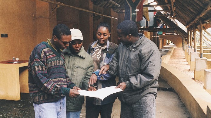 Students of the South African Wildlife College look at a plan together