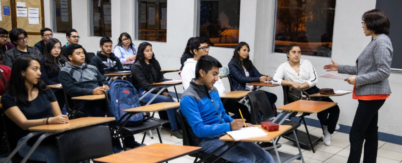 Teacher standing in front of students in a class