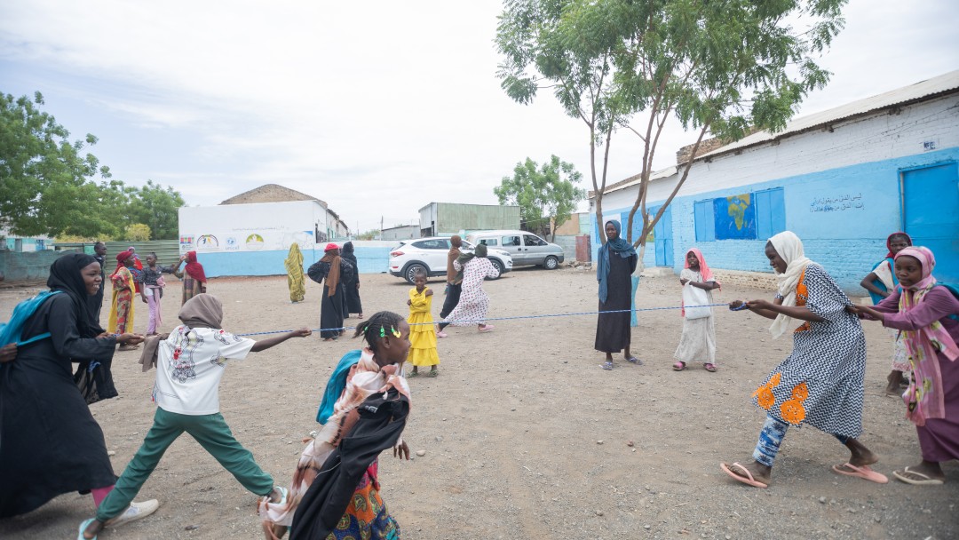 A group of children rope pulling