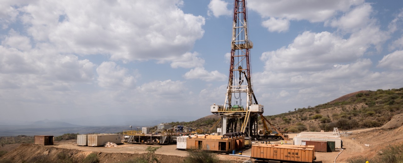 Drilling rig with workers and machines.